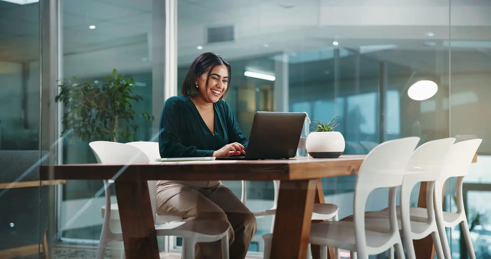Professional at wooden desk with laptop