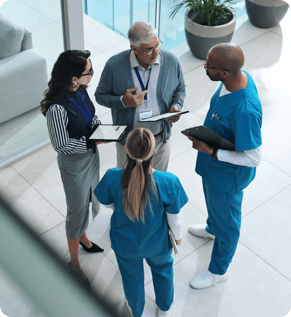 Medical professionals meeting in bright hallway